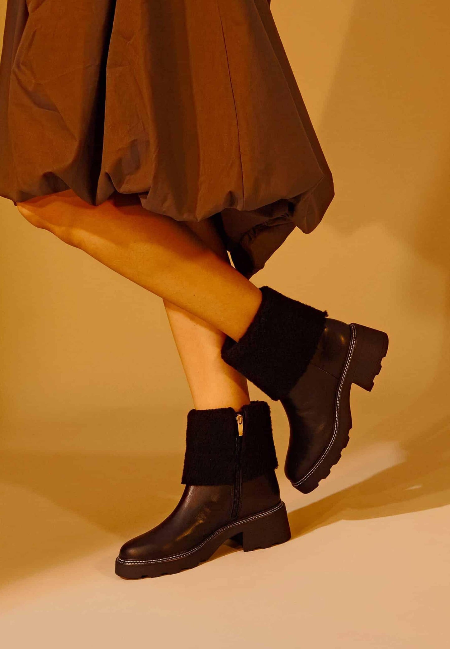 Lady wearing Black Ankle Boots with Stylish Shearling Detail