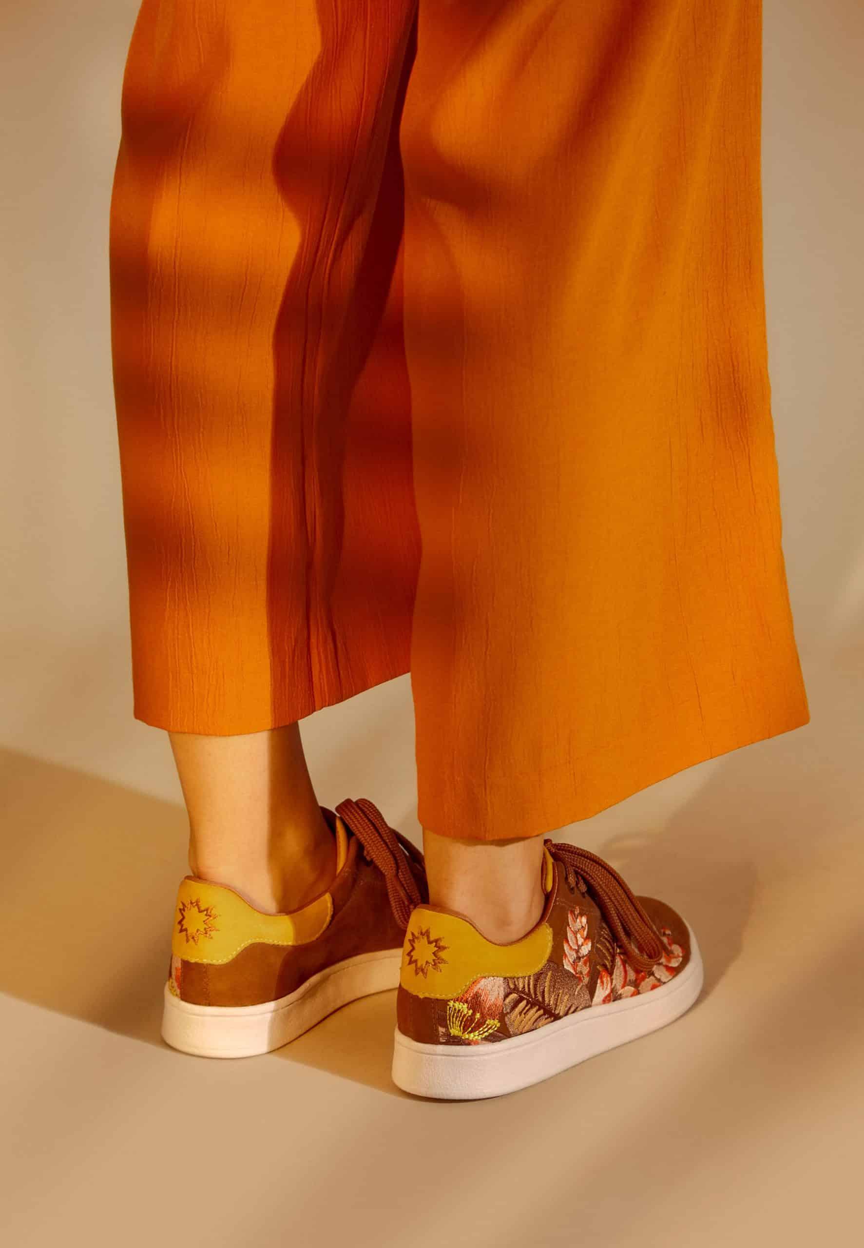 Woman Wearing Women's Brown Suede Floral Embroidered Sneakers.