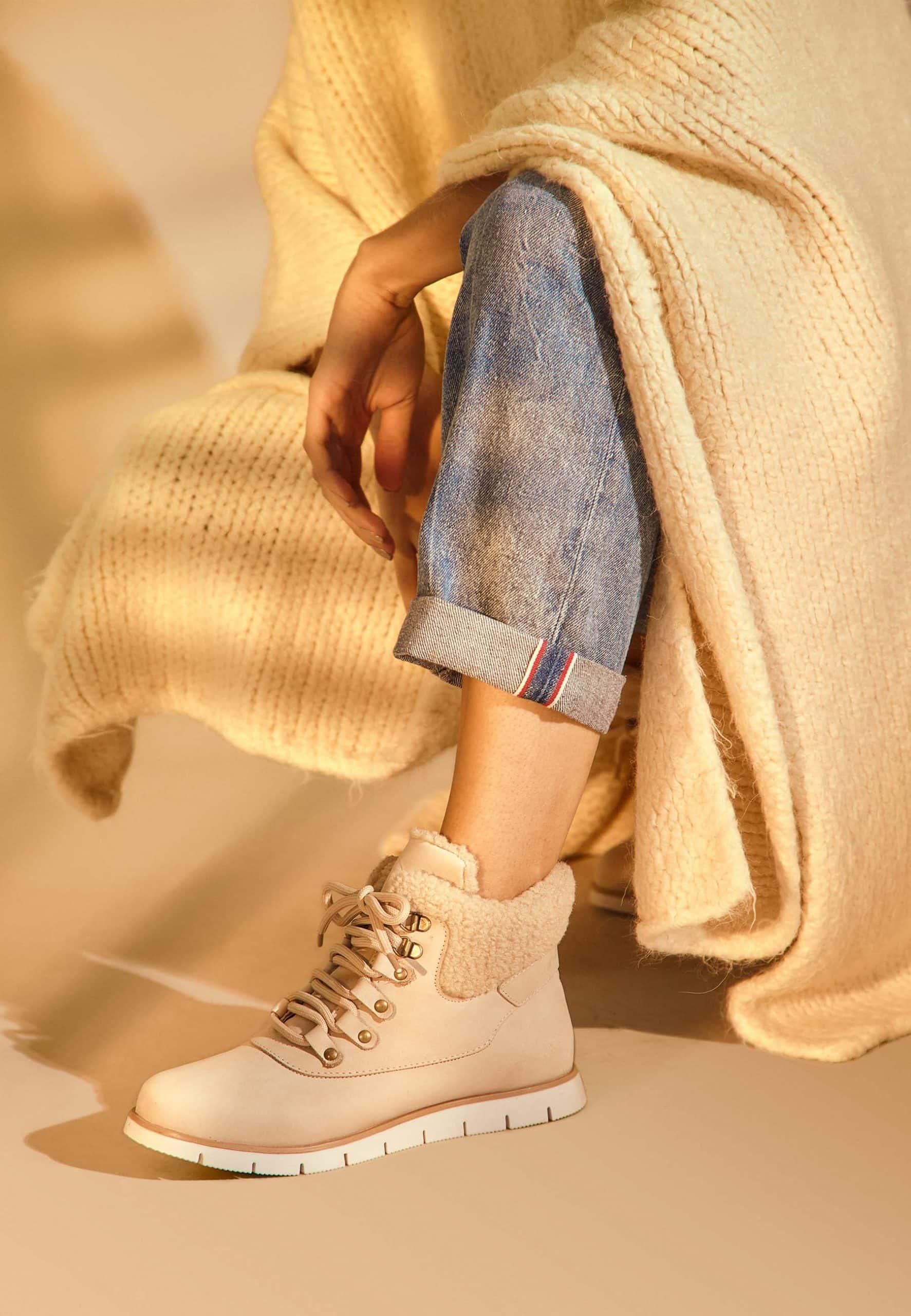 Woman wearing Women's Beige Suede Winter Boots with Shearing Embellishment.